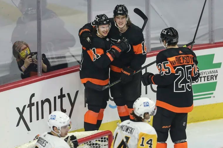 The Flyers' Travis Konecny (left) celebrates with teammates after scoring his second of three goals against the Penguins on Jan. 15. Konecny will return to the lineup this week after being on the COVID protocol list.