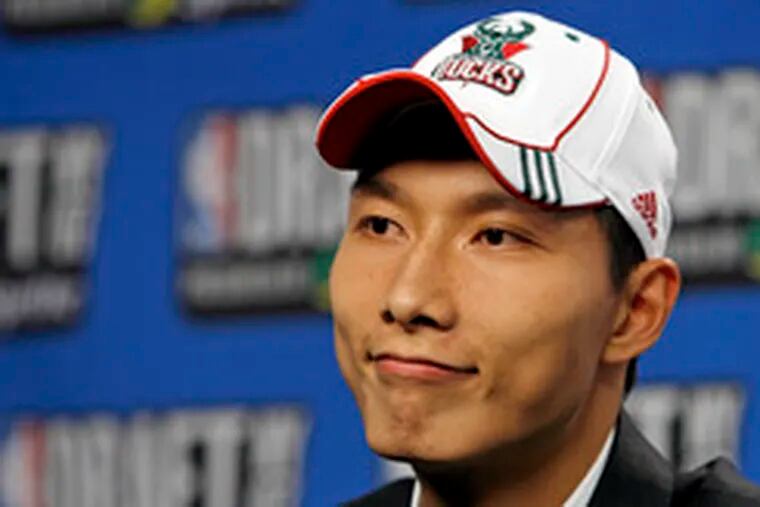 China&#0039;s Yi Jianlian puts on a happy face after being drafted by Milwaukee.