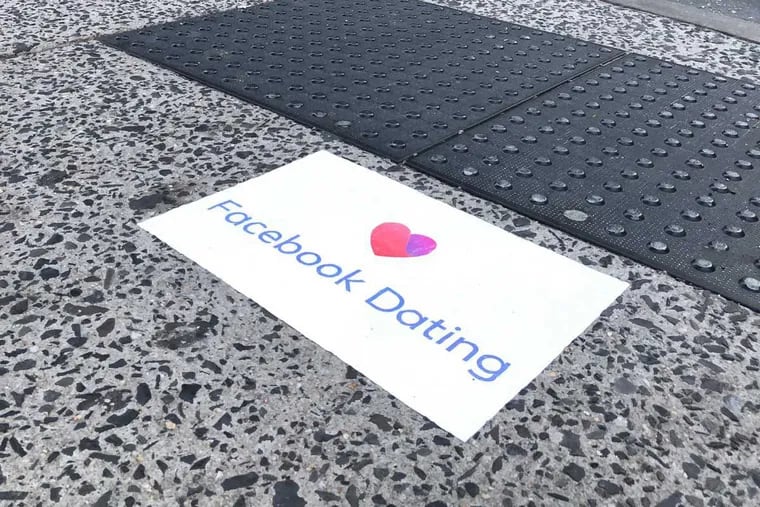 An ad for Facebook Dating on a Center City sidewalk.