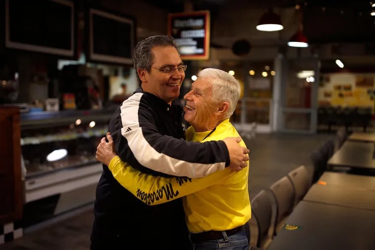 Vincent Iovine (left) of Iovine Bros. produce gives Pete Shovlin an early morning greeting at Reading Terminal Market on Saturday. Shovlin has been an early Saturday morning regular at the market for nearly a half-century.