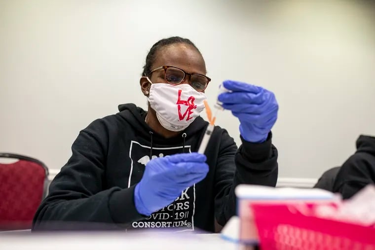 Dr. Ala Stanford fills up syringes with the COVID-19 vaccine at the Temple Liacouras Center on Feb. 20, 2021.