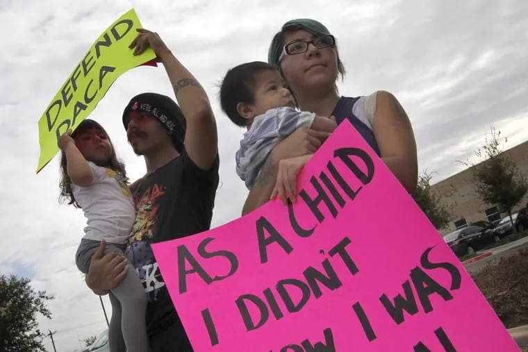 Kathia Ramirez, right, holds her son Rowen Salinas, 11 months, as her husband Randy Salinas holds their daughter Fridah Salinas, 2, during a protest in favor of Deferred Action for Childhood Arrivals (DACA)  in Texas.