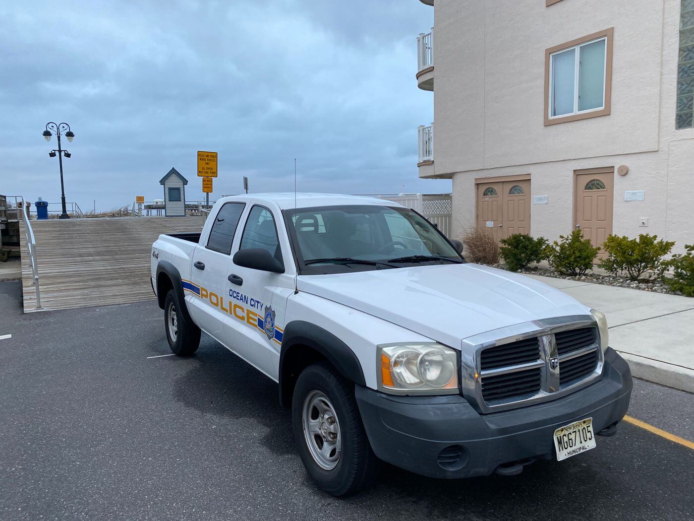 An Ocean City Police pick-up truck blocks the entrance to the boardwalk at 14th Street after the city shut down its beaches and boardwalk.