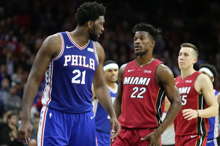 Joel Embiid, left, of the Sixers and  Jimmy Butler of the Heat exchange words during the 4th quarter at the Wells Fargo Center on Dec. 18, 2019.
