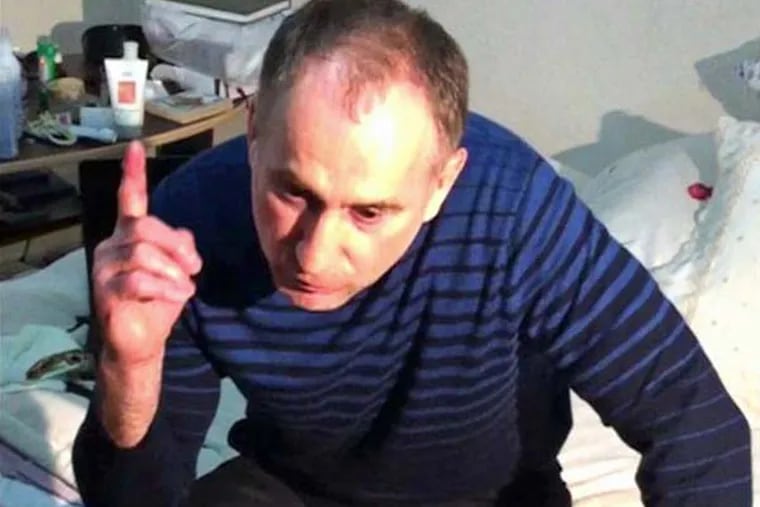 In this image taken from a mobile phone video, the father of USA Boston bomb suspects, Anzor Tsaraev reacts as he talks to the media about his sons, in his home in the Russian city of Makhachkala, Friday April 19, 2013.  One son is now dead, and one son Dzhokhar Tsaraev is still at large on Friday suspected in Monday's deadly Boston Marathon bombing which stunned friends who have pleaded for the surviving brother, described as bright and outgoing young man, to turn himself in and not hurt anyone.(AP Photo)