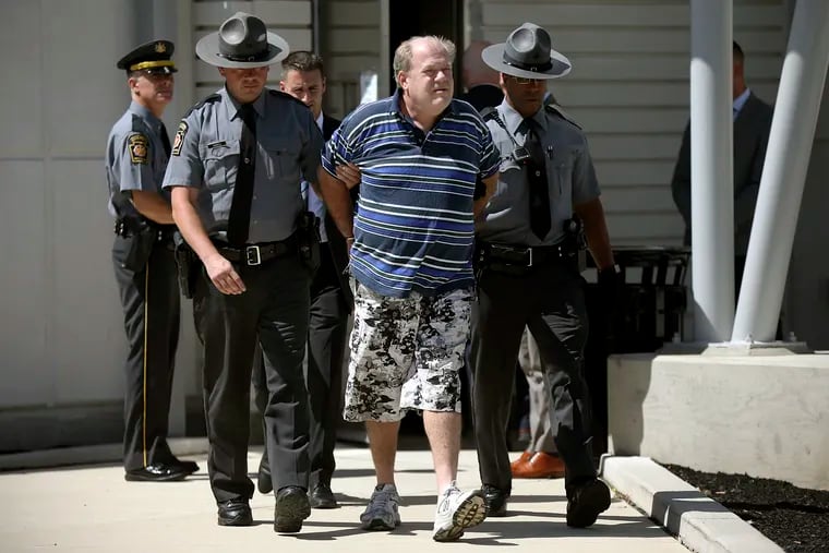 In a file photo from Tuesday, Sept. 3, 2019, Pennsylvania state troopers lead Theodore Dill Donahue out of the Pennsylvania State Police Troop K barracks in West Philadelphia after arresting him as a suspect in the 1991 murder of Denise Sharon Kulb.
