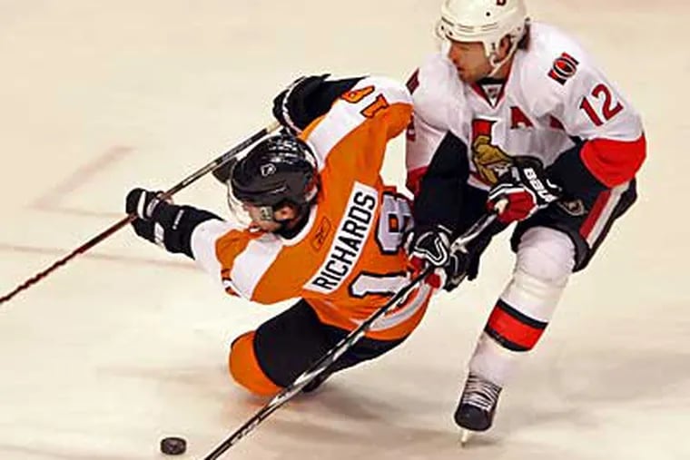 Flyers' Mike Richards is tripped by Senators' Mike Fisher during the
1st period.  The Senators won, 2-0.  (Steven M. Falk / Staff Photographer)