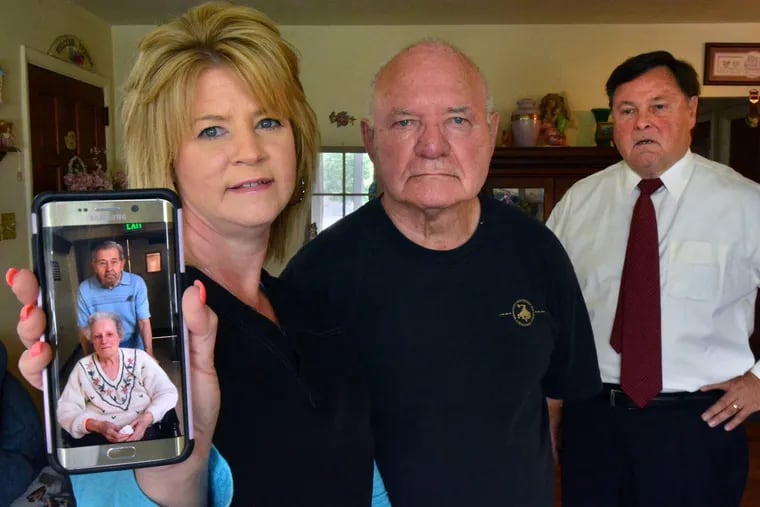 Heidi Austin and her father Joseph Wituschek display a photo of their family members, the Bergs. Also pictured is their attorney Daniel P. McElhatton,who convinced a judge to fire convicted felon  Gloria Byars as the Bergs’ financial guardian. MARK C PSORAS/For the Inquirer