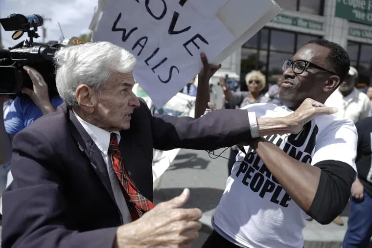 Donald Trump supporter Jerry Lambert (left) fights with Black Lives Matters supporter Asa Khalif outside a location in Philadelphia where Trump met with African American leaders. \r\n\r\n