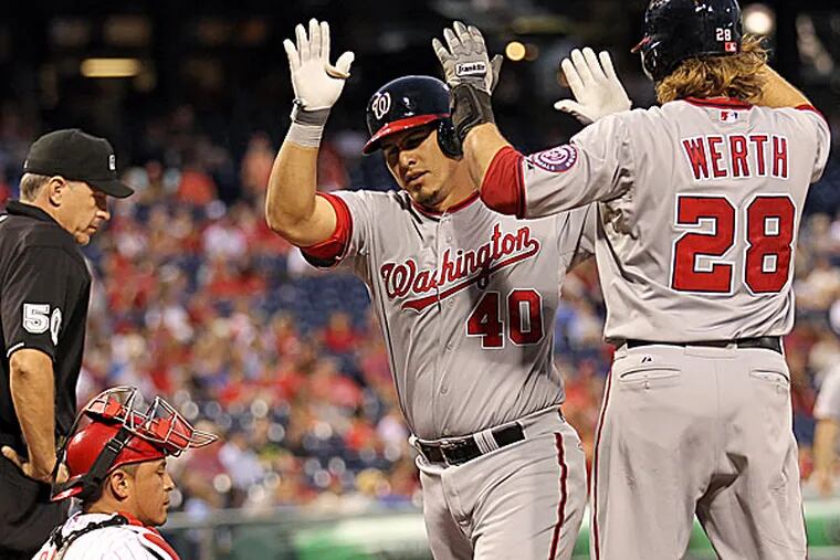 The Nationals' Wilson Ramos celebrates his three-run home run with teammate Jayson Werth as Phillies catcher Carlos Ruiz closes his eyes in the second inning. (Yong Kim/Staff Photographer)