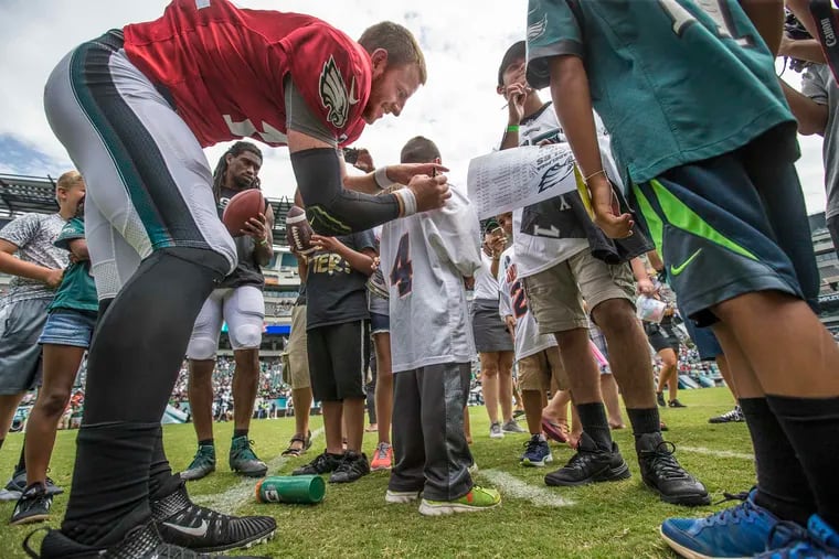 Eagles quarterback Carson Wentz signing a jersey during a past open practice at training camp.