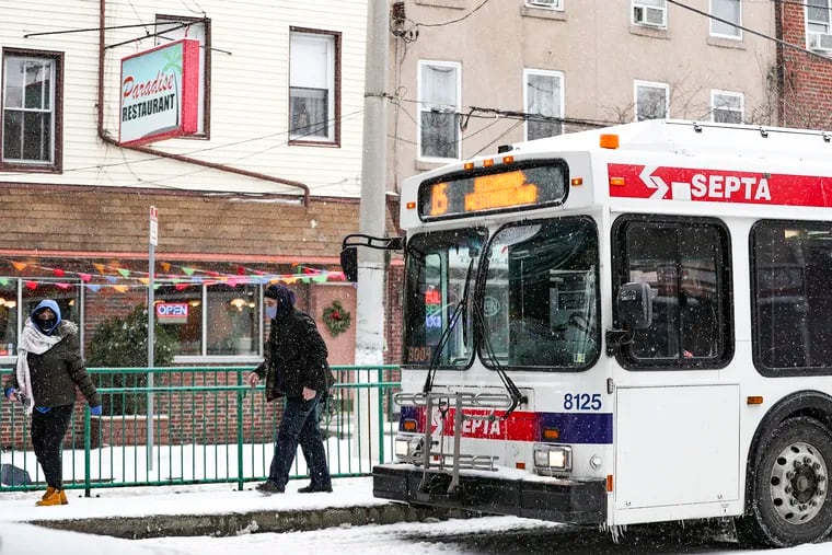 Pedestrians get off a SEPTA bus on Girard Ave. in the Fishtown section of Philadelphia on Thursday, Feb. 18, 2021.