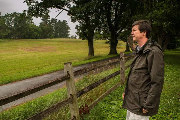 Brennan Preine looks at the land, part of an area set aside by William Penn to provide Schuylkill access from a colonial manor. (Matthew Hall/Staff)