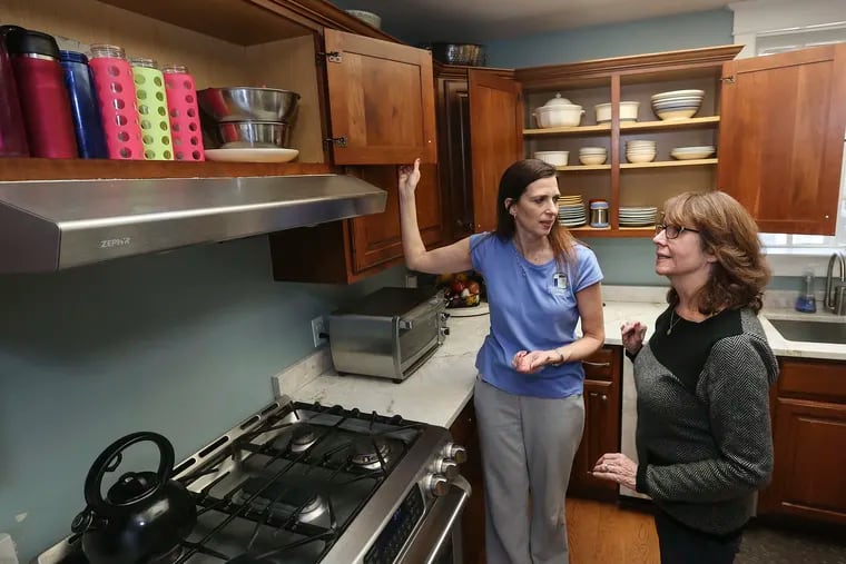 Professional organizer Darla DeMorrow talks with homeowner Elizabeth Gallagher about her kitchen in her Wayne, Pa., home. Monday, January 28, 2019.  STEVEN M. FALK  /  Staff Photographer
