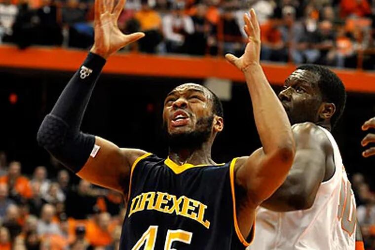 Drexel's Samme Givens tries to control the ball against Syracuse's Rick Jackson during the first half. (AP Photo/Kevin Rivoli)