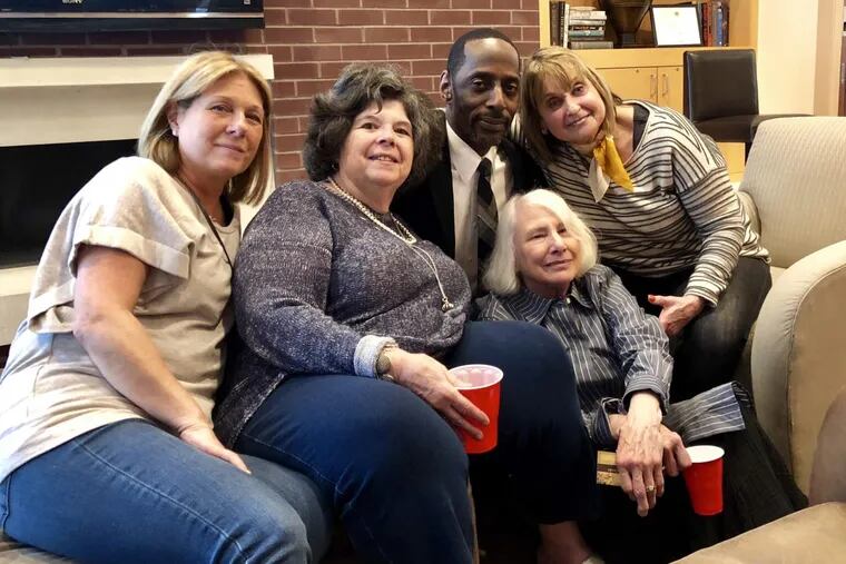 From left to right, Carla Rosanno, Leslie Field, concierge David Jackson, Gail Wright (seated), and Donna Sacks at the goodbye party organized by residents at the 777 South Broad apartment building.