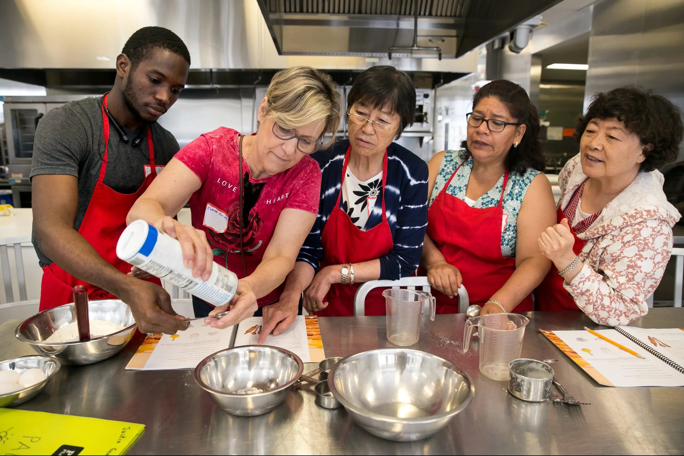 (L to R) Mamadou Hady Barry from Guinea, Ivana Guidelli from Brazil, Jiyun Li from China, Gloria Conchola from Mexico and Yu Qi from China collaborate on a project at the Free Library that uses cooking Teaching English to New Immigrants, at the Culinary Knowledge Center, Philadelphia Central Library, July 3, 2018.
