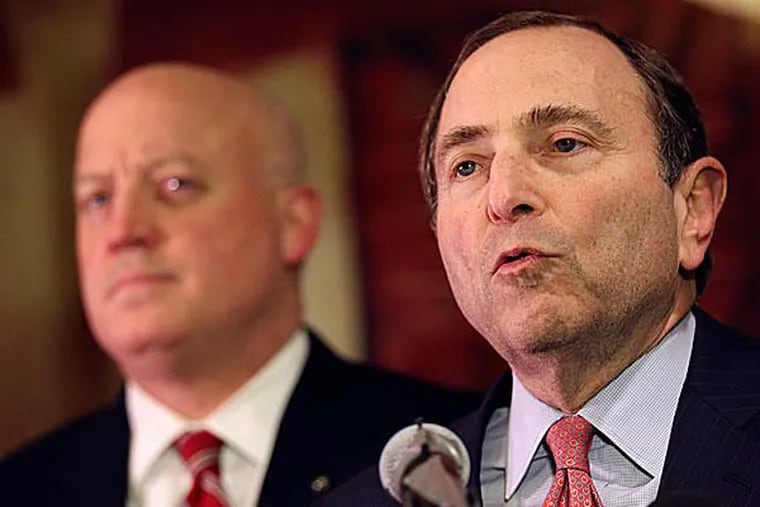 NHL commissioner Gary Bettman (right) and deputy commissioner Bill Daly and speak to reporters on Thursday. (Mary Altaffer/AP)