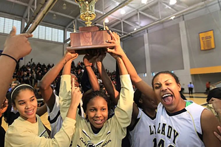 The Prep Charter girls' basketball team holds up its Public League Championship trophy. (Michael Bryant/Staff Photographer)