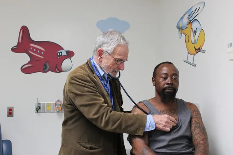 Dr. Elliott Vichinsky examines Derek Perkins at the sickle cell center at UCSF Benioff Children’s Hospital Oakland, which sees both children and adults.
