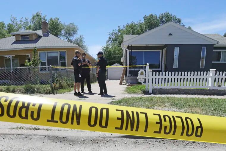 Police officers stand in front of the home, right, of Ayoola A. Ajayi Friday, June 28, 2019, in Salt Lake City. Authorities are filing murder and kidnapping charges in the death of a Utah college student who disappeared 11 days ago. Salt Lake City police chief Mike Brown said 31-year-old Ajayi will be charged with aggravated murder, kidnaping and desecration of a body in the death of 23-year-old Mackenzie Lueck.