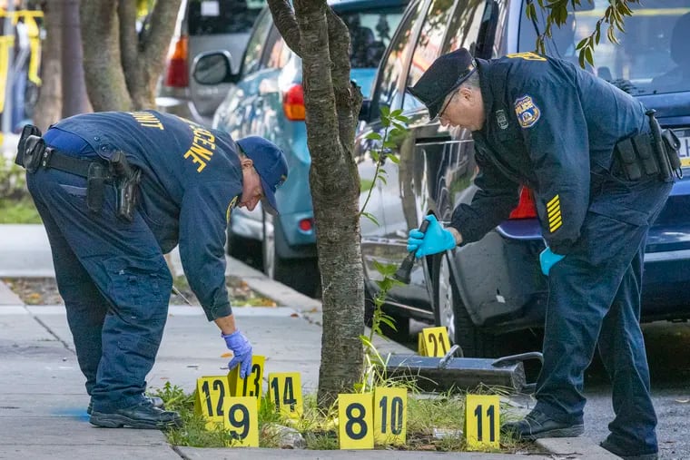 Crime Scene Unit officers mark evidence at the crime scene on the 800 Block of N. 10th Street after three SWAT officers were shot while serving a warrant.