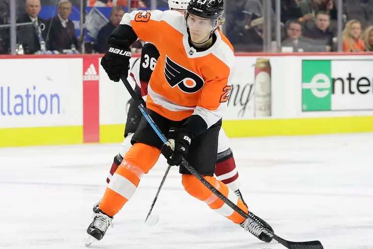 Flyers left winger Oskar Lindblom gets past Arizona Coyotes right winger Christian Fischer and fires a shot in a Dec. 5 game. He has been named the Flyers' Bill Masterton Trophy nominee.
