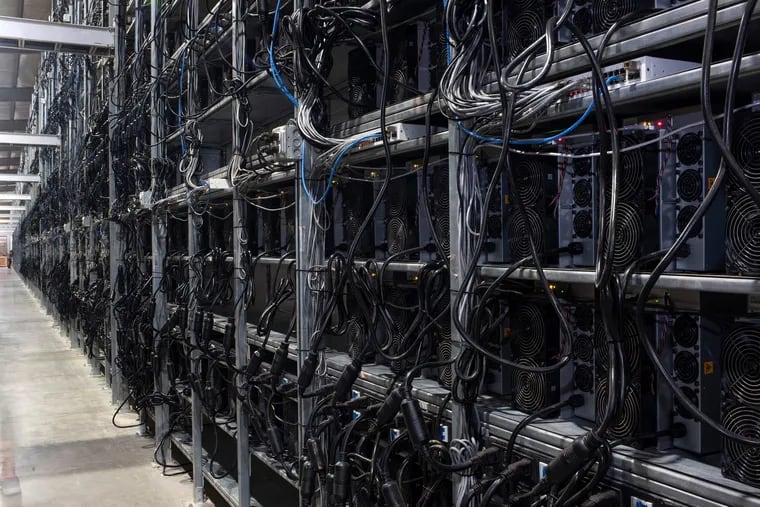 In this file photo, Bitcoin mining machines in a warehouse at the Whinstone US Bitcoin mining facility in Rockdale, Texas, on Oct. 10, 2021. (Mark Felix/AFP/Getty Images/TNS)
