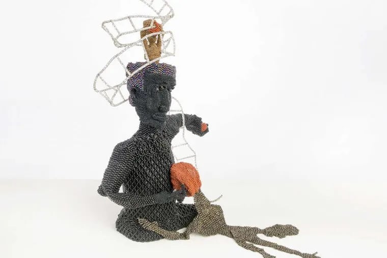 Joyce J. Scott’s “Buddha Gives Basketball to the Ghetto”; (1991), part of a retrospective at Grounds for Sculpture in Hamilton, N.J. (Collection of Carol Cole Levin)