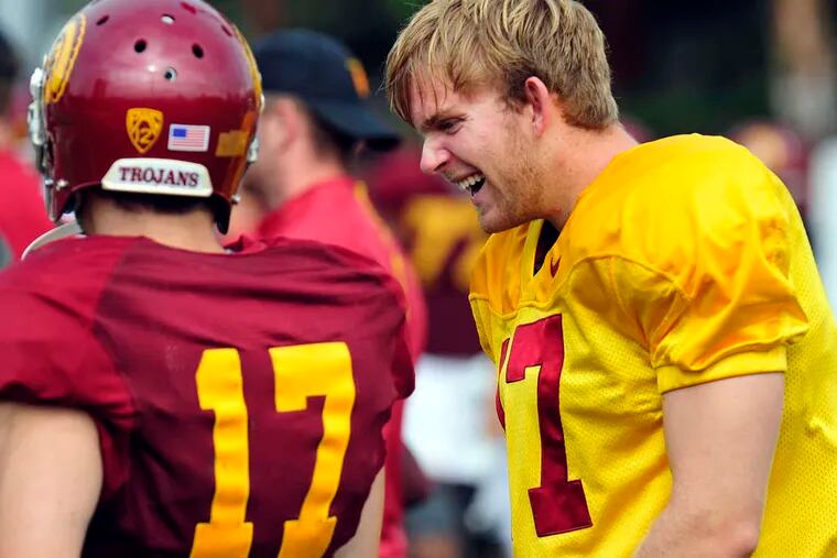 Southern Cal long snapper Jake Olson (right) jokes with teammates during practice last week.