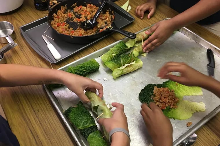 Students at Robert Pollock Elementary School in Philadelphia prepare stuffed cabbage as part of My Daughter's Kitchen healthy cooking program.