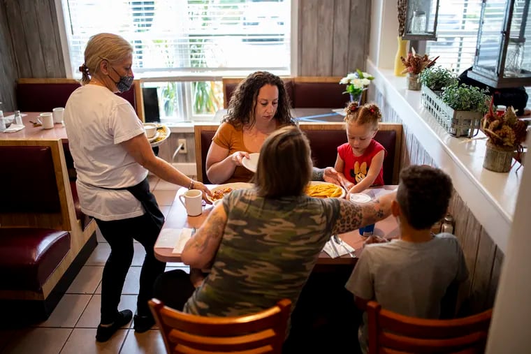 (Clockwise) Owner Debbie Brindisi, brings food for Cherish Moscagiuri, her two kids, Elliana Moore and Travis Moore, and Lauren Brousell at Lakeside Diner in Lacey Township, N.J., on Tuesday, Sept., 1, 2020. Moscagiuri have became regulars in the past two weeks since the diner opened.