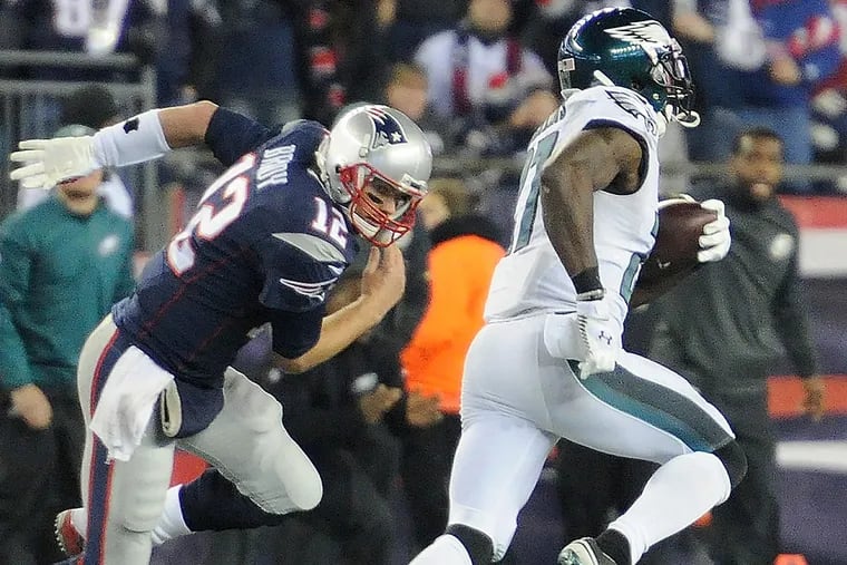 Patriots quarterback Tom Brady tries in vain to catch Eagles safety Malcolm Jenkins during an interception return in 2015.