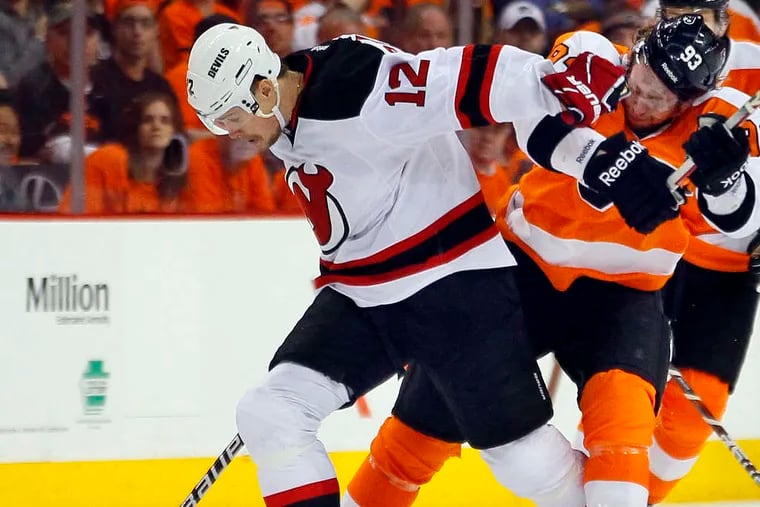 Devils forward Alexei Ponikarovsky muscles the Flyers' Jakub Vorcek off the puck during Game 2. The Devils have been outchecking and outworking the Flyers.