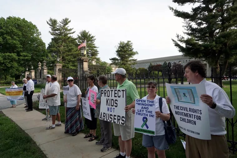 Demonstrators gather at St. Charles Borromeo Seminary in Wynnewood in support of a Pennsylvania measure to lift the civil statute of limitations in many child sex-abuse cases. Opponents warn such a change could be ruinous.