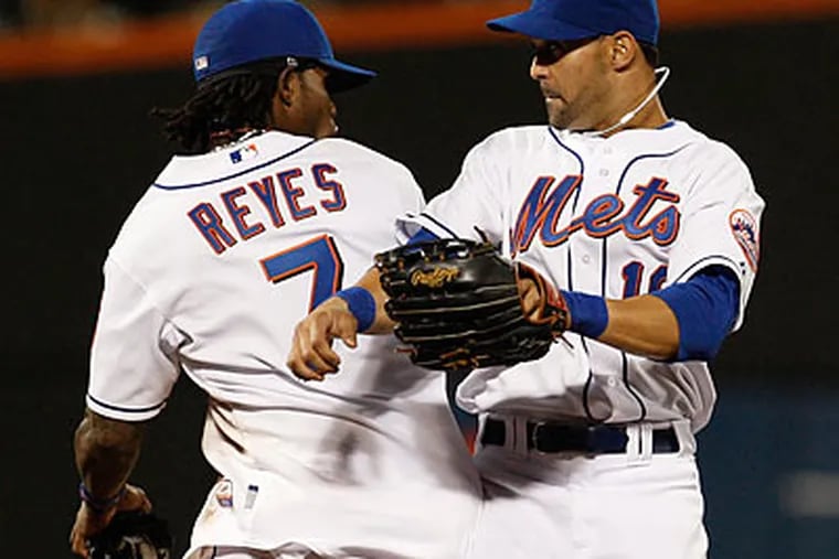 New York's Jose Reyes and Angel Pagan celebrate after wrapping up their shutout of the Phillies. (Kathy Willens/AP)