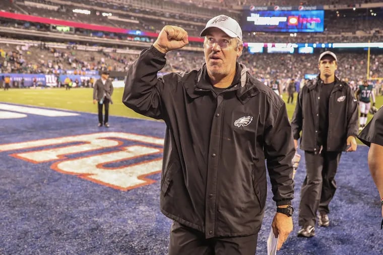 Eagle head Coach Doug Pederson raises his fist to the Eagle fans in MetLife Stadium at the end of the game as the Eagles win 34-13 over the Giants in Thursday nights game. MICHAEL BRYANT / Staff Photographer