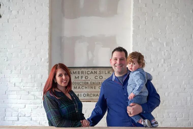 Jocelyn and Alex Garfinkel with their son at the new catering facility in Bridesburg.