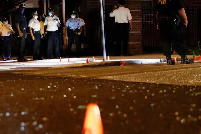 Philadelphia Police Commissioner Danielle Outlaw (third from left) tours the crime scene at Brown and Percy St. where at least 5 people were shot just after 11:30 p.m. on Saturday.