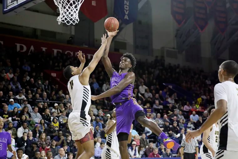 Roman Catholic sophomore center Jalen Duren, shown here shooting over Archbishop Wood’s Muneer Newton in the semifinals of the Philadelphia Catholic League tournament Feb. 19 at the Palestra, was named to the first-team, all-state squad Saturday by Pennsylvania sportswriters. In April, Duren transferred to Montverde Academy in Florida.