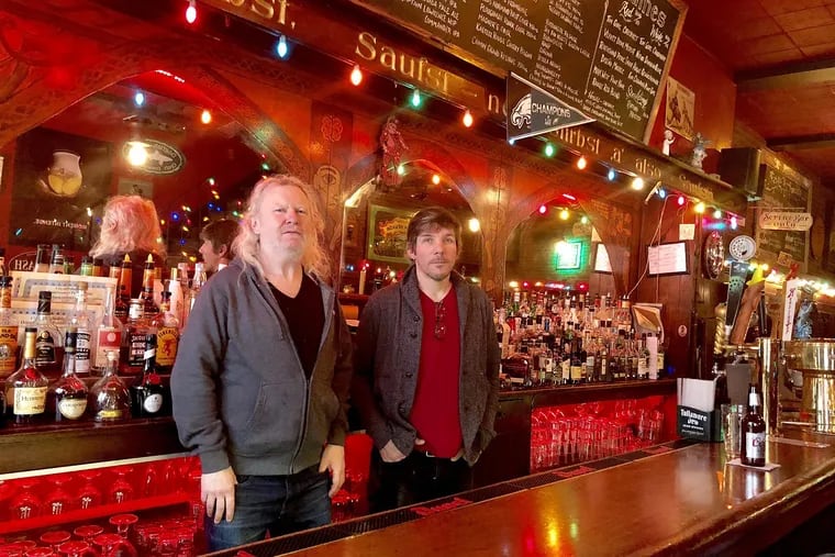 Fergus Carey (left) and Jim McNamara behind the bar at Fergie's.