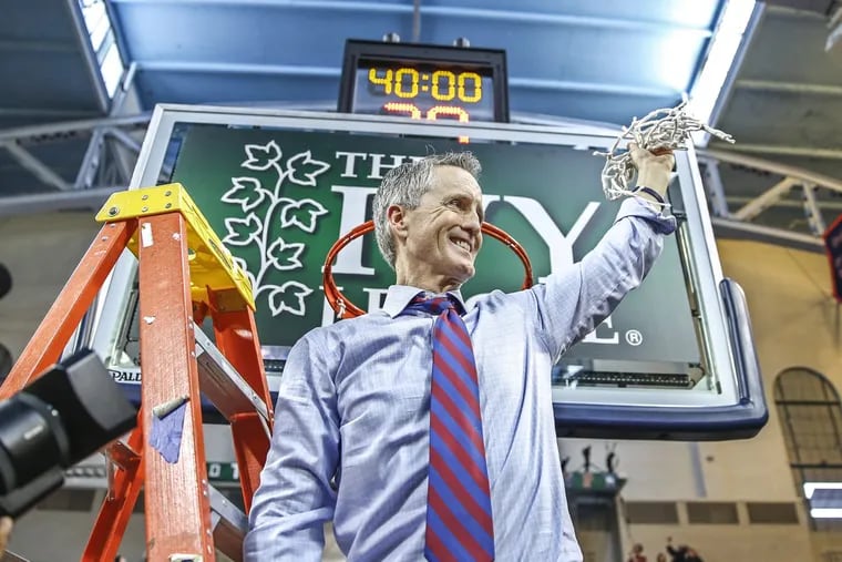 Penn men’s basketball head coach Steve Donahue celebrates after cutting the net down at the Palestra. The Quakers are going to the NCAA men’s basketball tournament for the first time since 2007.