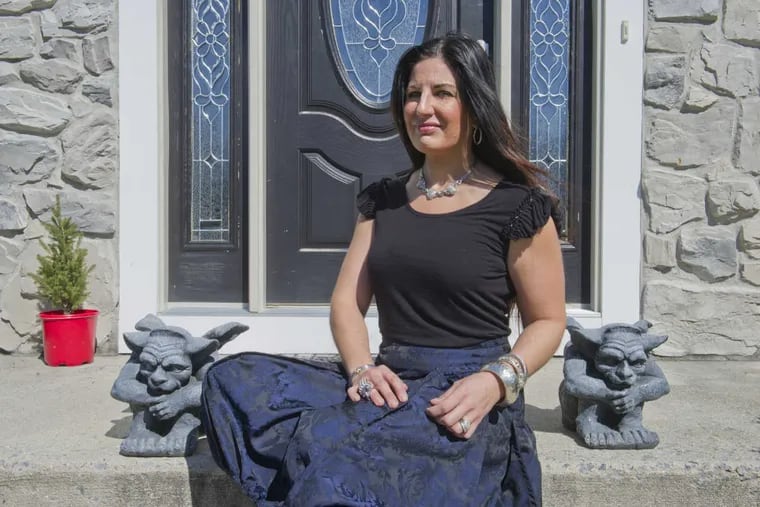 South Jersey poet Nicole Rollender, who just received an $8,600. grant from the NJ State Arts Council, sits on the front stoop of her Williamstown, NJ home.