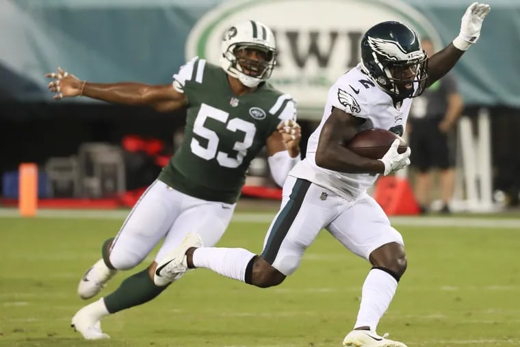 Eagles wide receiver DeAndre Carter runs with football past New York Jets linebacker Kevin Minter in the first-quarter during a preseason game on Thursday, August 30, 2018. MICHAEL BRYANT / Staff Photographer