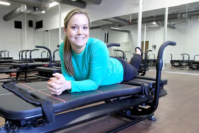Hilary Ryan, a former Wall Streeter, is opening Plank Studio in Wayne, Pa. She is shown in the main workout room with the Mega Former machine on April 1, 2014. It is the first Pennsylvania studio to feature these machines. (CHARLES FOX/Staff Photographer)