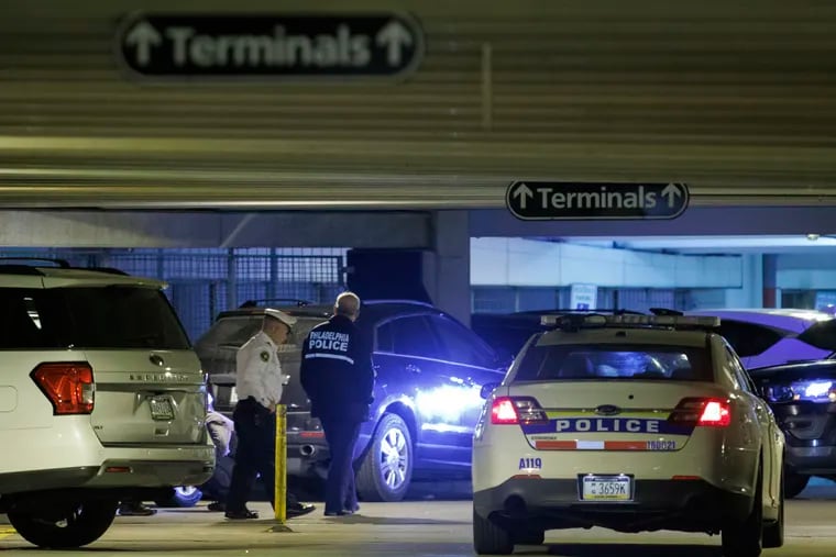 Philadelphia police officers and patrol car inside Terminal D parking lot at Philadelphia International Airport on Friday morning October 13, 2023. Two officers were shot in the parking lot, one died.
