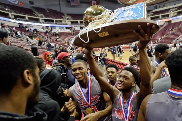 Imhotep players sharing the trophy with their fans after beating Sharon to win the 2018 Class 4A state championship.