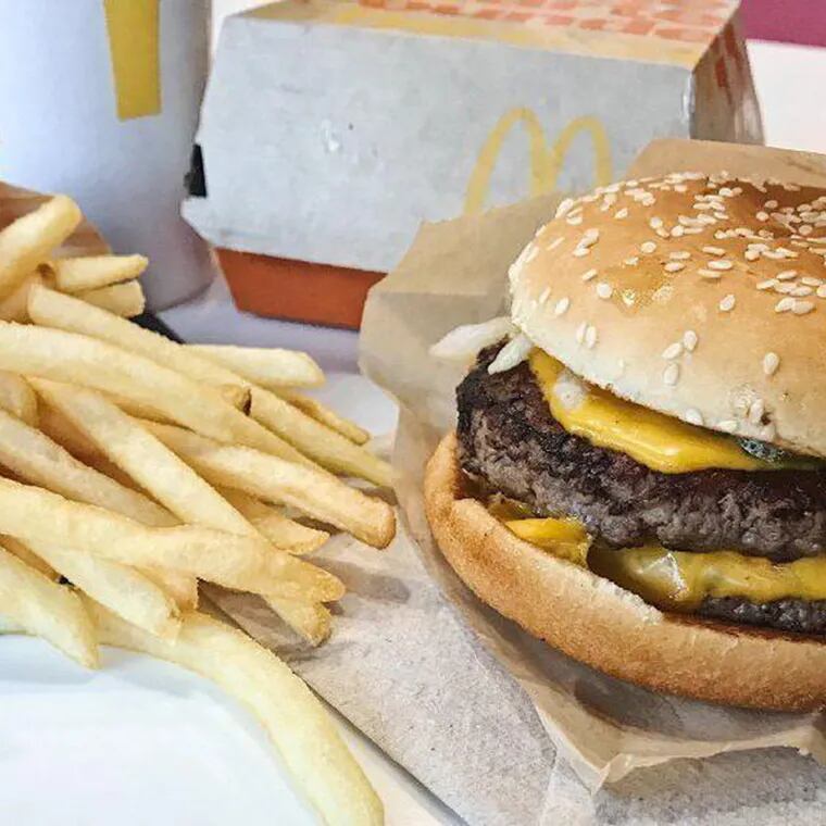 A McDonald's cheeseburger and an order of french fries in 2018.