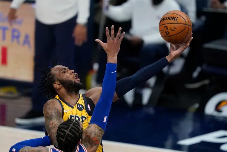 Indiana Pacers' Oshae Brissett  puts up a shot against the 76ers' Mike Scott during the second half.