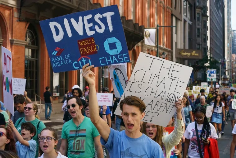 Protestors march on Locust Street between 14th and 15th Streets during a climate change protest, in Philadelphia, September 19, 2019. JESSICA GRIFFIN / Staff Photographer
